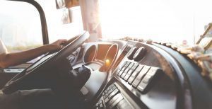 Mental Health Tips for Truckers Hand on Steering wheel in semi
